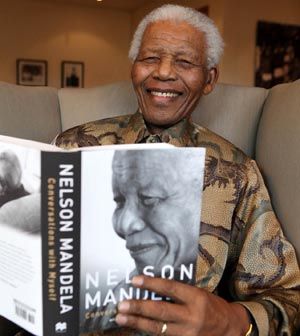 In this photo released by the Mandela Foundation, former South African president Nelson Mandela smiles as he holds the Soccer World Cup trophy at the Mandela Foundation in Johannesburg last week (AP/Mandela Foundation)