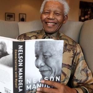 Former president Nelson Mandela with his book Conversations with Myself, which contains excerpts of his private journals, letters and personal notes. (Debbie Yazbek, Nelson Mandela Foundation, Sapa)