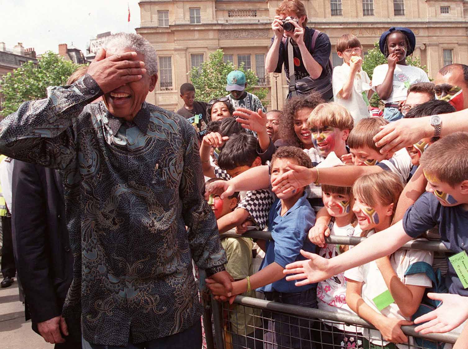 South Africa's President Nelson Mandela walks amongst the vast Trafalgar Square crowd in London on July 12 1996. The President later addressed the crowd from the balcony of South Africa House.