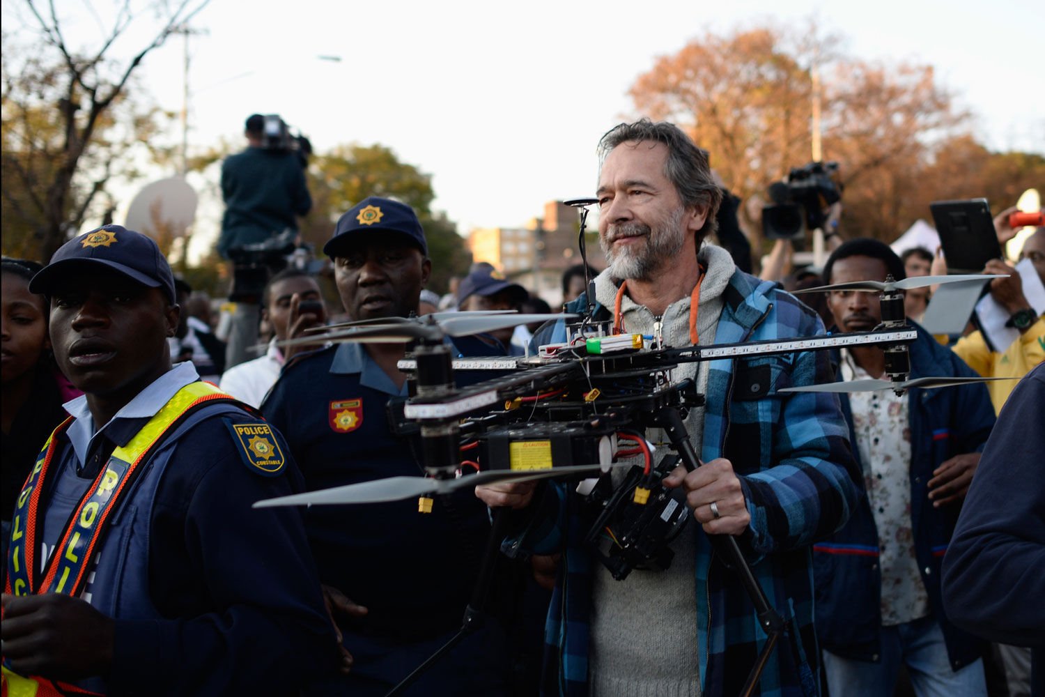 Police detain FC Hamman carrying a radio-controlled helicopter drone with a camera that was filming scenes around the Pretoria hospital where Nelson Mandela is being treated. (Dylan Martinez, Reuters)