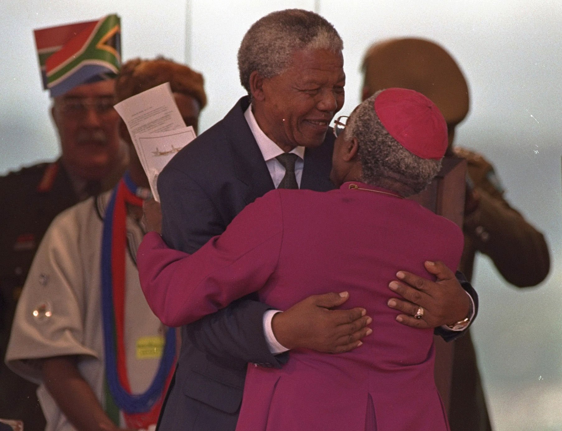 Former President Nelson Mandela gets a hug from Archbishop Desmond Tutu after Mandela was sworn in as president of South Africa at the Union Buildings in Pretoria on May 10 1994.