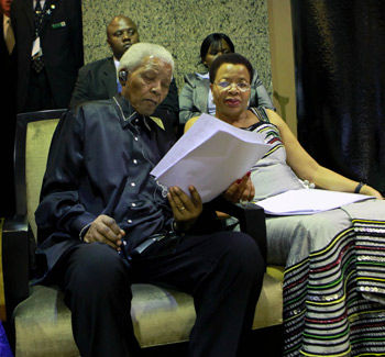 Nelson Mandela, accompanied by his wife Graça Machel, reads President Jacob Zuma’s State of the Nation speech in Parliament on Thursday night.