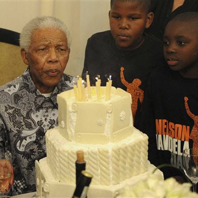 Nelson Mandela blows out candles as he celebrates his birthday in Johannesburg on Sunday. (AP)
