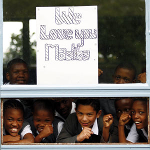 Children from a school adjacent to Milpark hospital in Jo'burg show off a placard for Nelson Mandela when he was hospitalised last month. (Siphiwe Sibeko, Reuters)