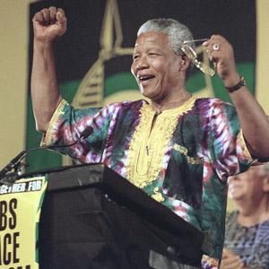 Former president Nelson Mandela acknowledges cheers from a Soweto crowd as he prepares to unveil the ANC's official election platform in January 1994. (David Brauchli, AP)