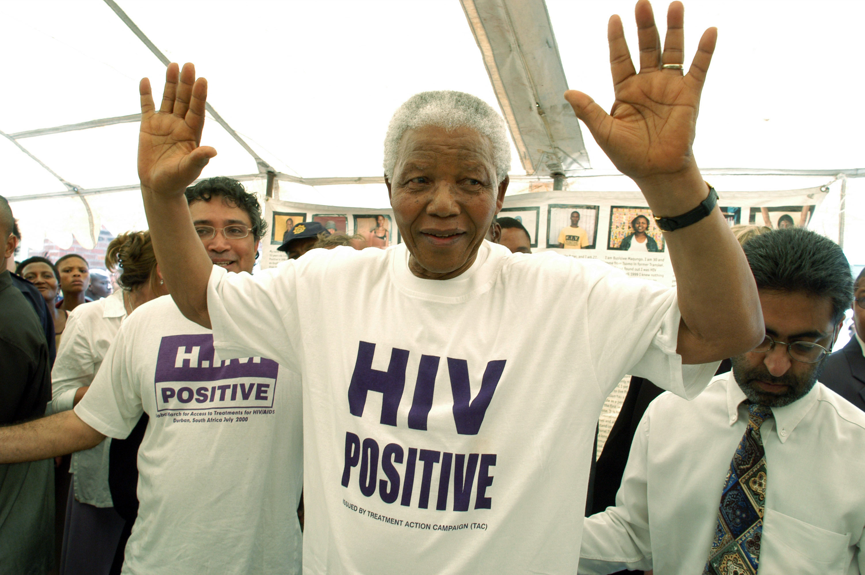 Nelson Mandela, sporting an 'HIV positive' tshirt, visits the township of Khayelitsha in Cape Town with the Treatment Action Campaign on December 2 2002. 