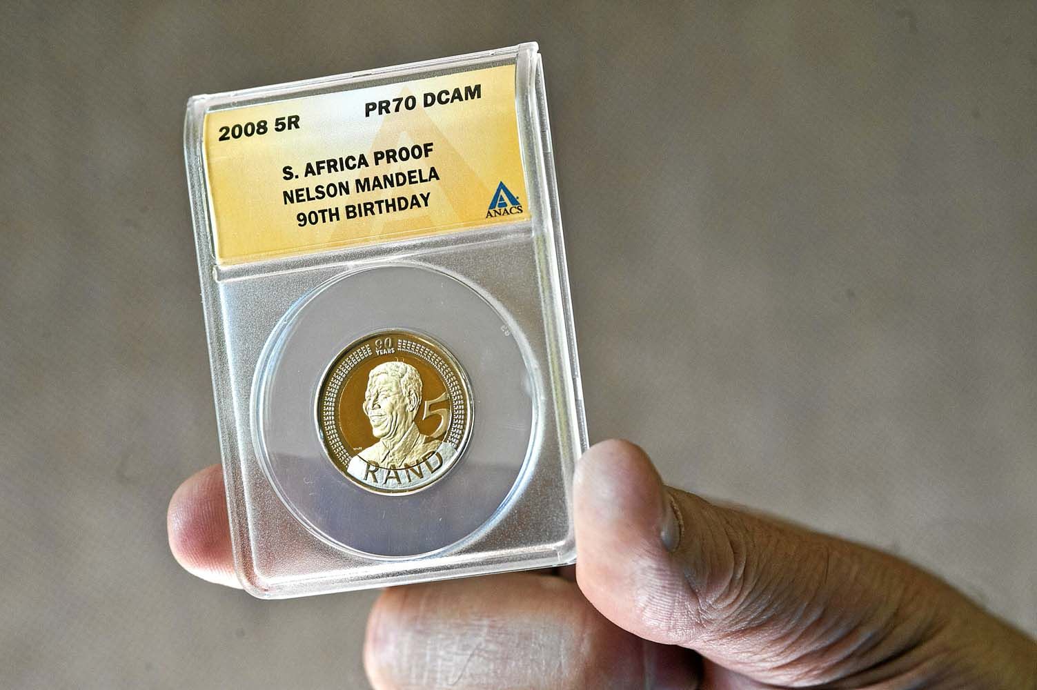 The sale of Mandela keepsakes, like the coin above, have been slow. Photo: Delwyn Verasamy