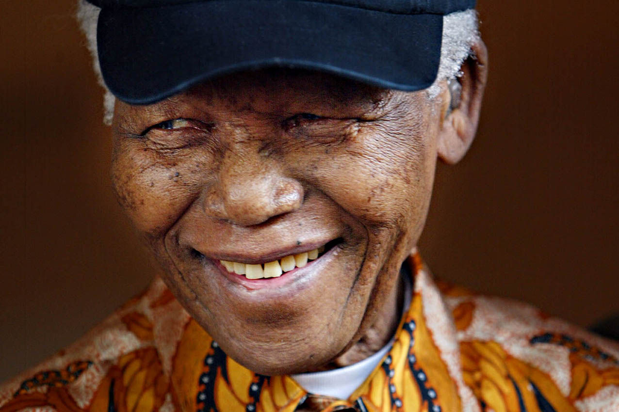 Former South African President Nelson Mandela smiles on October 26 2005, as he wears the US baseball team 'white socks' cap which was gifted to him.